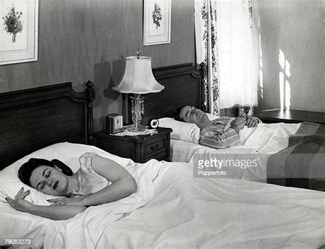 Couple Sleeping In Separate Beds Photos Et Images De Collection Getty