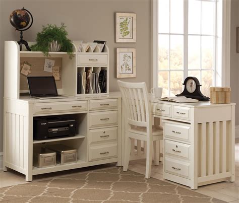 A corner computer desk with a hutch on top, made out of solid wood with a coat of white paint and a shiny, polished top surface. Liberty Furniture Hampton Bay - White L-Shaped Desk with ...