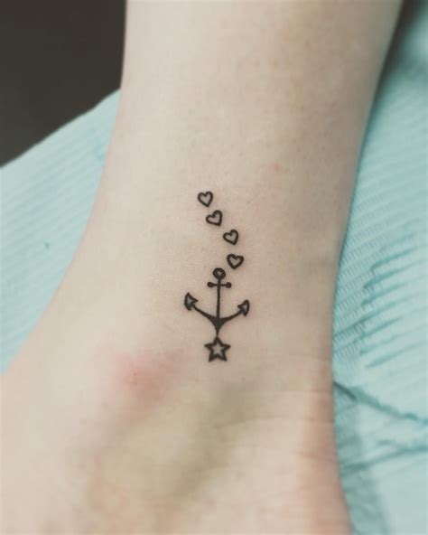 Black Anchor With Hearts And Star Tattoo On Left Ankle Small Anchor