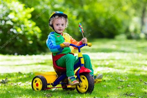 Little Boy On Colorful Tricycle Stock Photo By ©famveldman 116282730