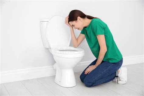Young Woman Suffering From Nausea At Toilet Bowl Space For Text Stock