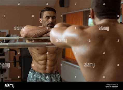 Muscular Man Flexing Abdominal Muscles Abs In A Health Club Stock Photo