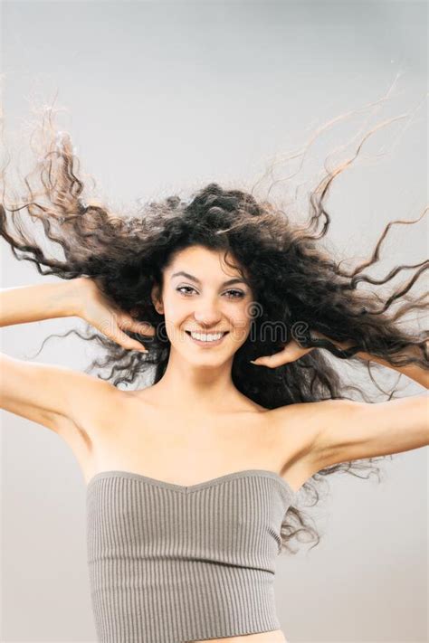Beautiful Brunette Girl With Long Curly Hair In The Air Studio