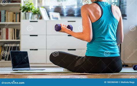 Home Workout Concept Woman In Living Room With Laptop And Dumbells