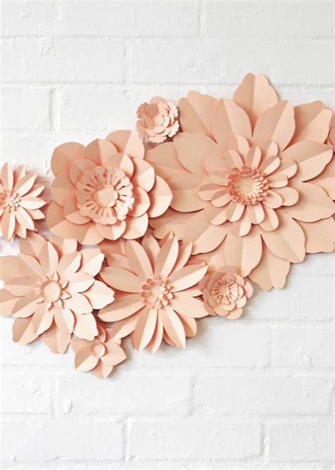 She uses a variety of colors to make four different flower types in all different sizes for a stunning display. Set Of 11 Handmade Paper Flowers By May Contain Glitter | notonthehighstreet.com