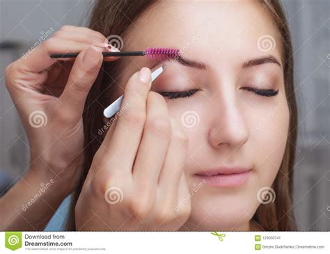The Make Up Artist Plucks Her Eyebrows From A Young Woman In A Beauty