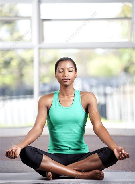 Young Woman Sitting Cross Legged In A Gym Stock Image F0342284