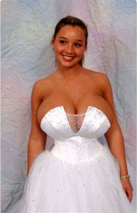A Woman In A White Dress Posing For The Camera