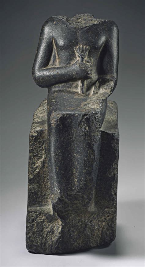 An Egyptian Black Granite Seated Sculpture For Neith Overseer Of The