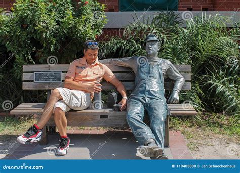 Man On A Bench With The Sculpture Lunchbreak By J Seward Johnson On