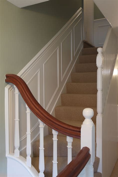 A Staircase With White Railing And Wood Handrails