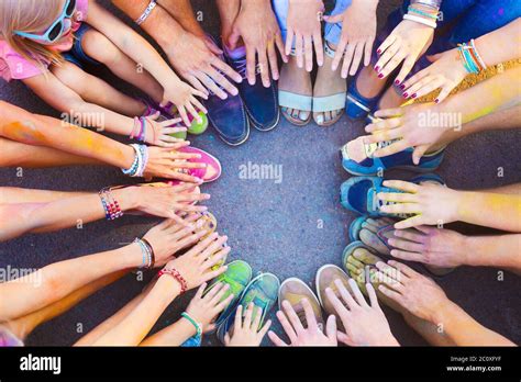 Friends Putting Their Feet And Hands Together In A Sign Of Unity And Teamwork Stock Photo Alamy