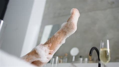 close up woman feet in foam bath unrecognized girl washing legs in bathtub stock footage