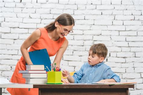 Mother Helping Her Son To Do The School Homework Stock Image Image Of