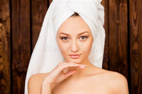 Attractive Girl With Towel On Her Head In Spa Salon Touching Chin Stock Photo Image Of Relax