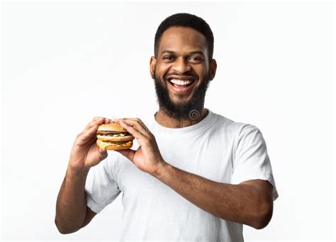 Happy African American Man Posing With Burger Studio Shot Stock Photo