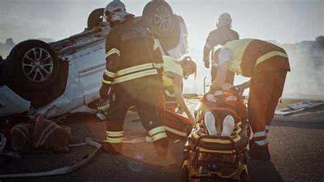 On The Car Crash Traffic Accident Scene Rescue Team Of Firefighters