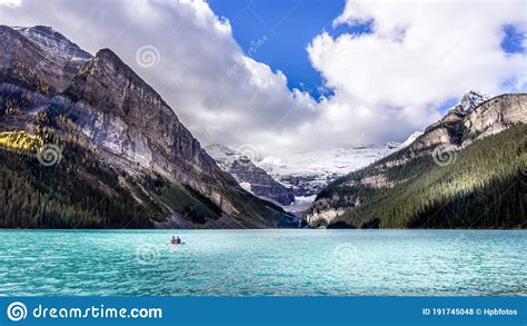 Canoeing On The Turquoise Waters Of Lake Louise In The Rocky Mountains