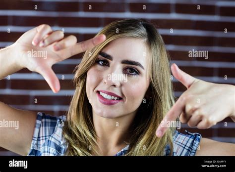 Pretty Blonde Woman Making Signs With Her Fingers Stock Photo Alamy