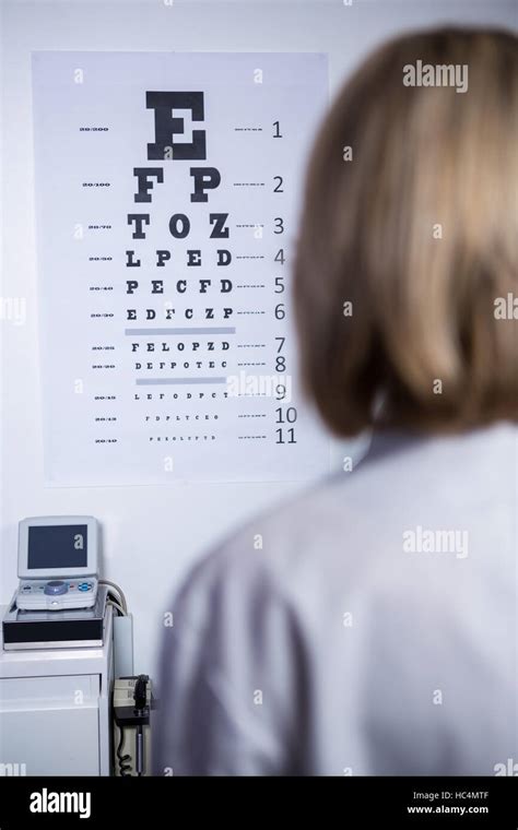 Optometrist Looking At Eye Chart Stock Photo Alamy