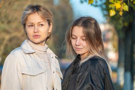 two beautiful girls lgbt lesbian girlfriend outdoors in the evening autumn sun stock image
