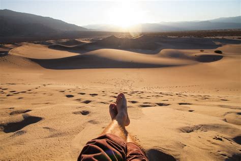 Man Sitting On Desert During Daytime Photo Free Sand Image On Unsplash