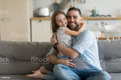 Close Up Headshot Portrait Picture Of Smiling Father Hugging Daughter