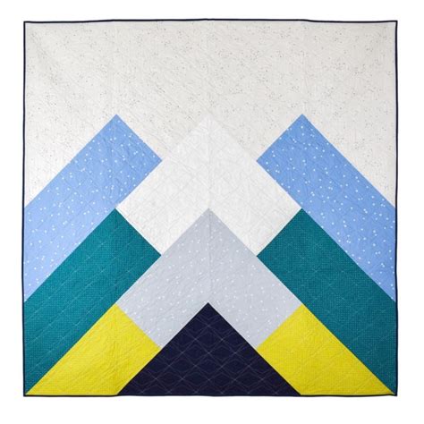 A Blue And Yellow Quilt Hanging On A Wall