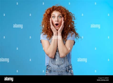 amazed gasping shocked wondered redhead attractive curly girl popping eyes stare camera drop jaw