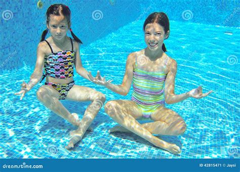 Two Girls Underwater In Swimming Pool Stock Photo Image