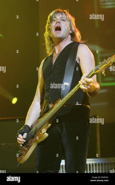 Def Leppard Bassist Rick Savage Is Shown Performing On Stage During A Concert Appearance Stock