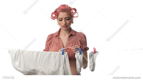 Beautiful Portrait Of Pin Up Girl Housewife Hanging Clothes Stock Video
