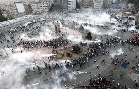 Protesters Run As Riot Police Fire Teargas During A Protest At Taksim