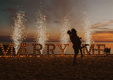 Magical Sunset Beach Proposal With Marquee Letters And Sparklers