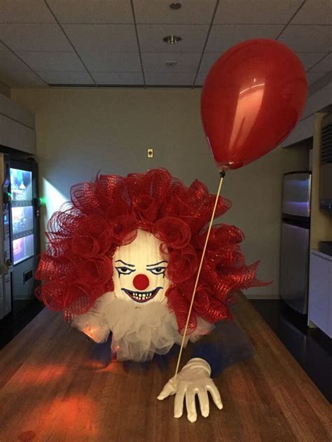 A Creepy Clown Holding A Red Balloon On A Wooden Floor In An Office Building With Wood Floors