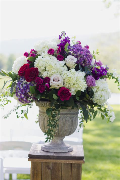 Plan a funeral, find contact information and more. Altar flowers in a stone urn in soft whites mixed with ...
