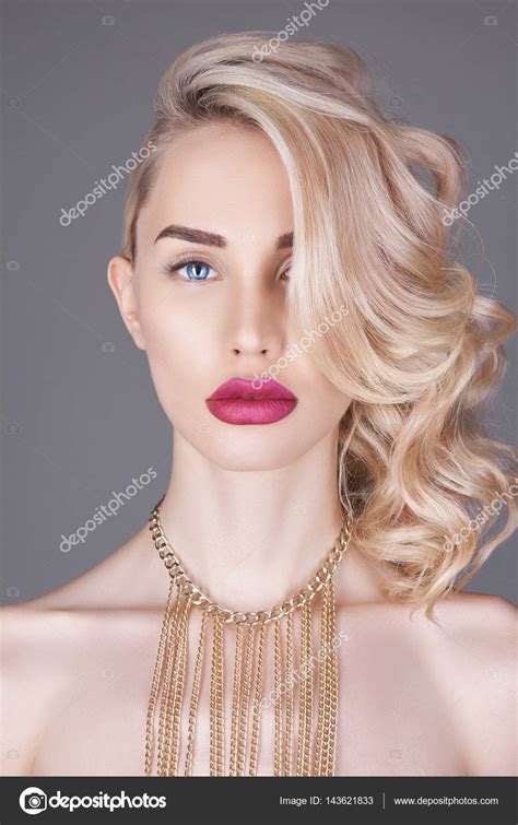 fashion beauty nude blonde woman on a light background girl with jewels on the arms and neck