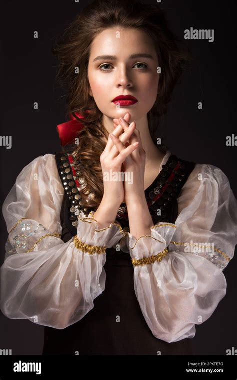 beautiful russian girl in national dress with a braid hairstyle and red lips beauty face