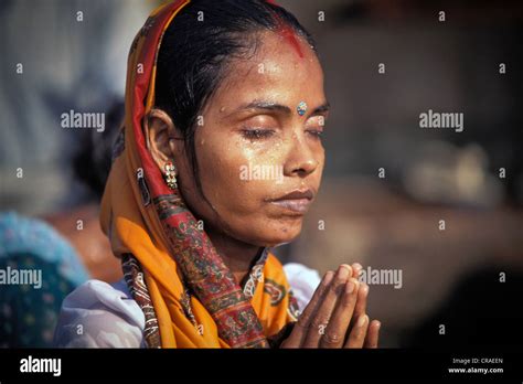 woman with closed eyes in deep prayer ritual bath ghats ganges river kashi varanasi or
