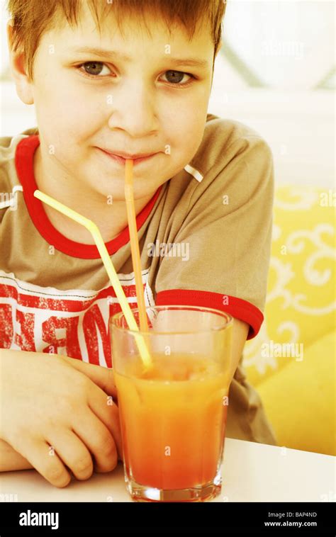 Boy Drinking Orange Juice Stock Photo Alamy