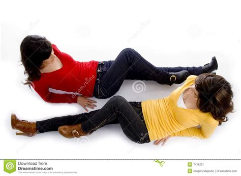 Two Friends Looking At Each Other While Lying Head To Shoulder Stock