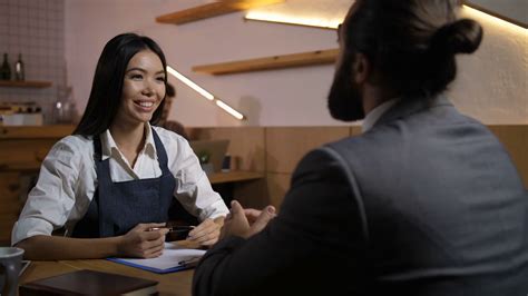 Beautiful Female Employer Interviewing Male Candidate For Vacant