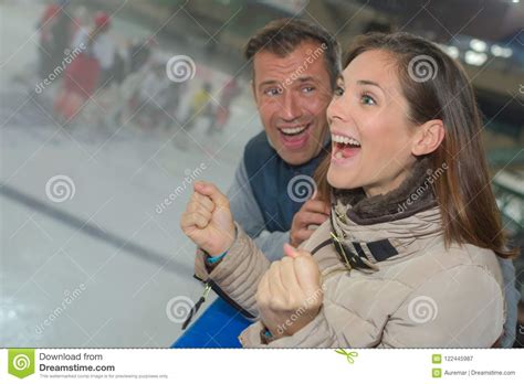 Excited Couple Cheering On Ice Hockey Team Stock Image Image Of Skate