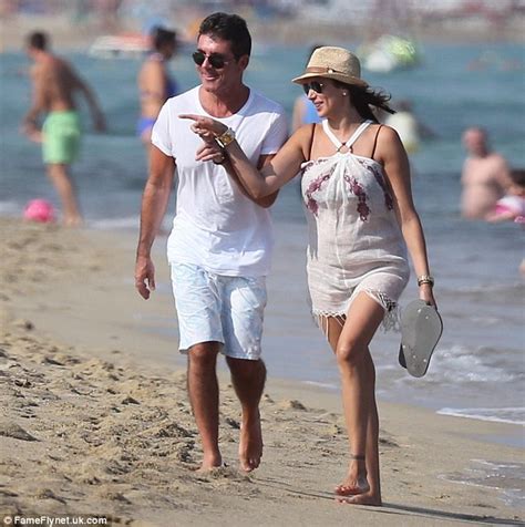 simon cowell holds hands with pregnant lauren silverman during beach stroll daily mail online