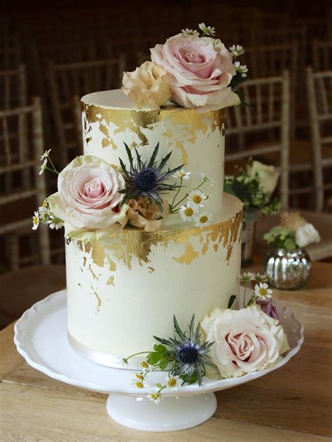 No doubt that a cake will always be a center of attention but if you long for a truly smashing effect to impress all your guests and make them talk about your legendary big day long after it. Smooth buttercream wedding cake with edible gold gilding ...
