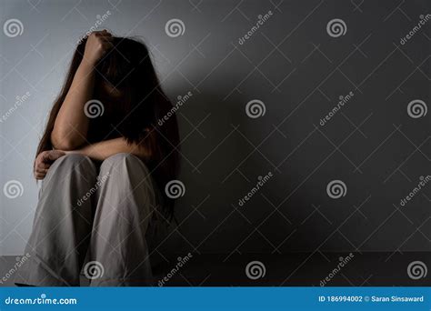 Sad Woman Hug Her Knee And Cry Sitting Alone In A Dark Room Depression