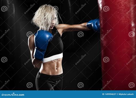 Female Boxer Hitting A Punching Bag At A Boxing Studio Woman Boxer