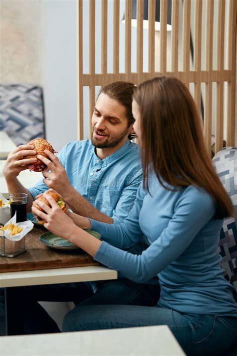 People Having Dinner Eating Burgers At Cafe Stock Image Image Of
