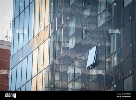 Background Of An Glass Office Building Reflecting Grey Sky In The