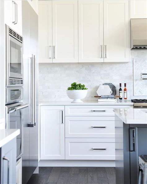 Shaker style kitchen with white cabinetry and black appliances. Pin by E G on Kitchens in 2019 | Shaker kitchen cabinets ...